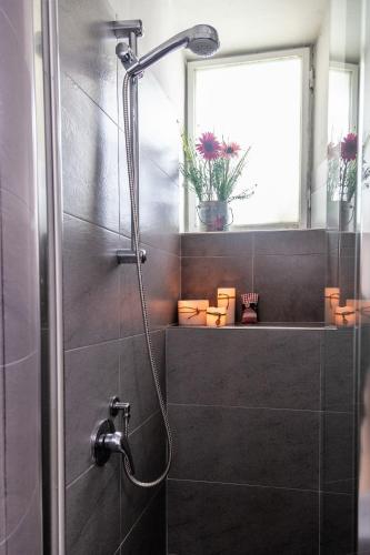 a bathroom with a shower with a glass door at La Colonna (Historic Centre) in Lucca