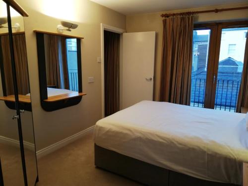 Een bed of bedden in een kamer bij Molesworthcourt Suites