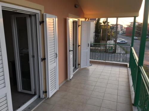 a balcony with doors and a view of a street at Pinpoint Rooms in Mesolongion
