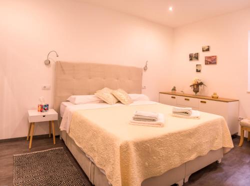 una camera da letto con un grande letto con due asciugamani di L'ArcoBaleno a Rovigno (Rovinj)