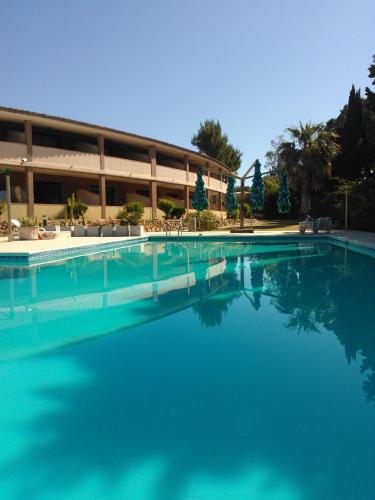 a large pool of water in front of a building at Verdemare Sardegna Uno in Villasimius