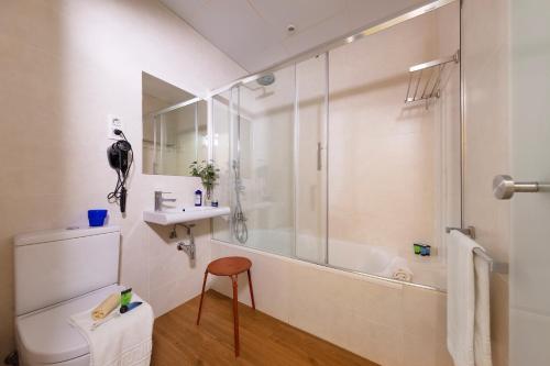 a bathroom with a shower and a toilet and a sink at Som Nit Born in Barcelona