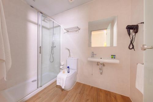 a bathroom with a shower, sink, and toilet at Som Nit Born in Barcelona