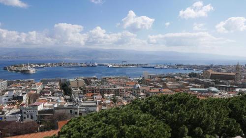 a view of a city with a harbor and water at Three Rooms in Messina