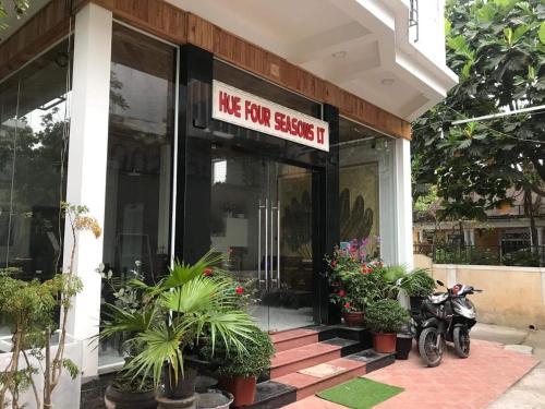 a motorcycle parked in front of a store front at Hue Four Seasons Hotel in Hue