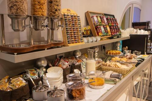 a buffet with a lot of food on a table at Hotel Centrale Best Western Signature Collection in Tirano