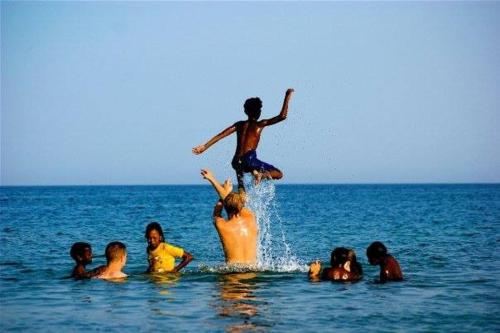 a group of children playing in the water at Deep south Eco-lodge in Marsa Alam City