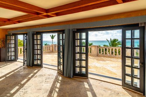 a room with doors open to the beach at Sanctuary Cap Cana, a Luxury Collection Resort, Dominican Republic, Adult All-Inclusive in Punta Cana