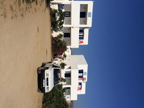 an aerial view of a white building on a cliff at Aronis Plaka Naxos in Plaka