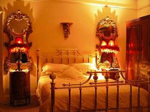 a bedroom with two beds with lights on them at Charlemont House in Dungannon