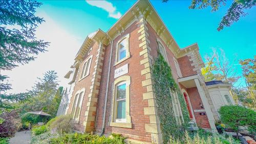 a brick building with ivy on the side of it at Norfolk Guest House Inn in Guelph