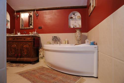 a bathroom with a white tub and a sink at RESIDENZA D'ORIA B&B in Foggia