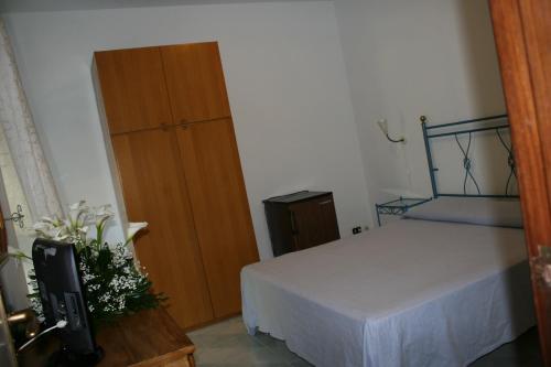 a bedroom with a bed and a wooden door at Villaggio Villa Lubrense in Massa Lubrense