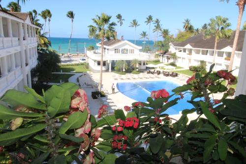 a view of a resort with a swimming pool and the ocean at Albachiara Hotel - Las Terrenas in Las Terrenas