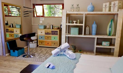 a living room with a pair of shoes on the floor at Milly's Touch Studios in Roodepoort