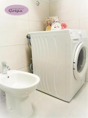 a bathroom with a washing machine and a sink at Apartment Gospa in Pula