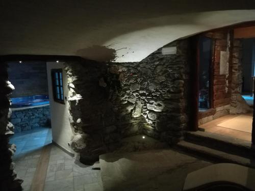 a room with a stone wall in a house at B&B La Maison D' Amelie Camere e Appartamenti in Fenis