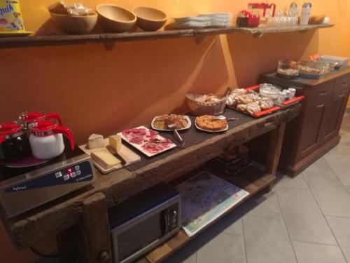 a table with many different types of food on it at B&B La Maison D' Amelie Camere e Appartamenti in Fenis