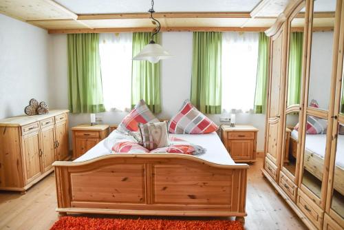 a bedroom with two bunk beds and green curtains at Ferienhaus Schneiderhäusl Zillertal in Stummerberg