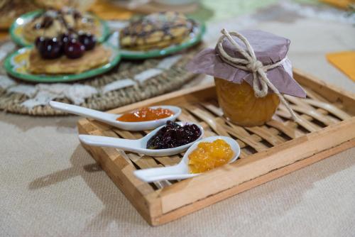 a tray of food with spoons and jam and fruit at Il Brillocco in Castellabate