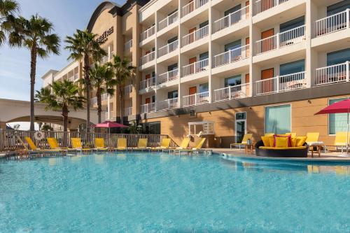 a large swimming pool in front of a hotel at DoubleTree by Hilton Galveston Beach in Galveston