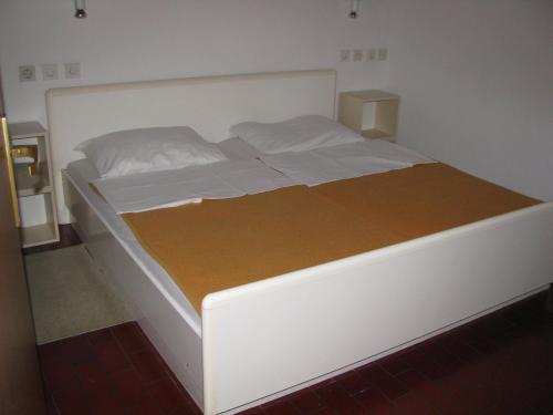 a large white bed in a bedroom with avertisementatronatronstrationstration at Apartma Ravbar Portorož in Portorož