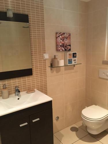 a bathroom with a toilet and a sink at Casas do Mar - Baleal 1 - Sea House in Baleal