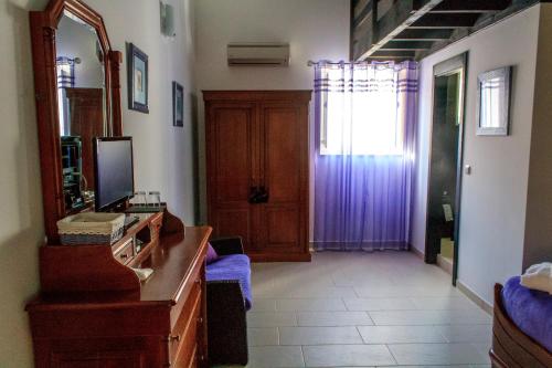 a room with a dresser and a mirror and a door at Refugio no Campo - AL 1683 in Rapoula do Côa