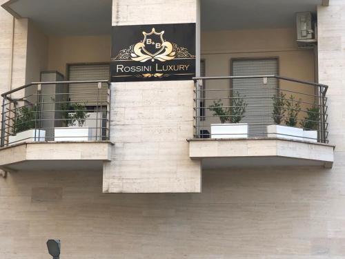 a building with two balconies with plants on it at B&B Rossini Luxury in Rende