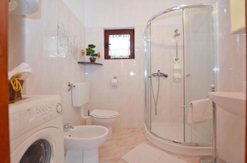 a bathroom with a shower and a toilet and a sink at House Nada in Rovinj