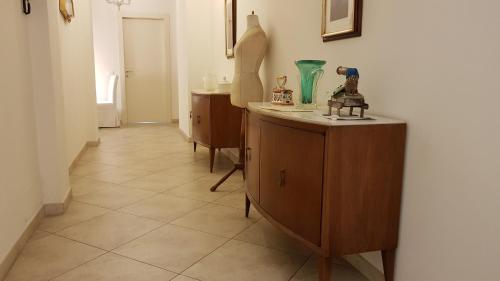 a hallway with wooden cabinets and a vase on a table at Atelier Cosseria in Florence