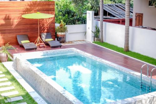 a swimming pool in the backyard of a house at La Mai Hotel in Chiang Mai