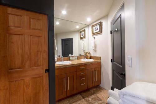 a bathroom with two sinks and a wooden door at A Sunset Chateau in Sedona