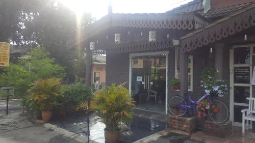 a building with a bike parked in front of it at HOTEL SHAFURA 2 in Cukai