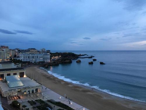 a view of a beach and the ocean at night at BIARRITZ Victoria Surf in Biarritz
