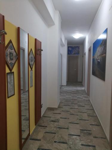 a corridor of a room with a tile floor at Vigata House in Porto Empedocle