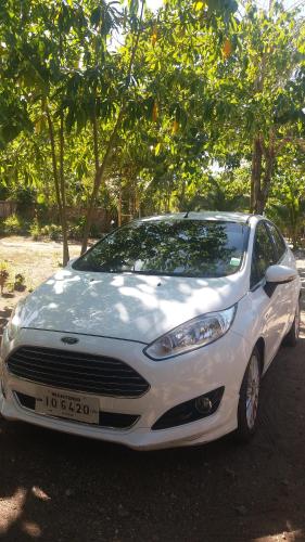 a white car parked in front of some trees at Villa catalina Bora 2 Resort in Nabas