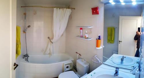 a bathroom with a tub and a toilet and a sink at Face à l'océan - Boulevard de la mer - T3 in Hendaye