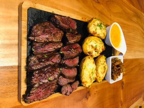 a tray of meat and potatoes on a table at JEZ&SPI Plánice in Plánice