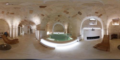 a large bathroom with a green tub in a building at ReLuxe Private Wellness in Lecce