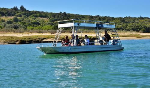 a group of people sitting on a boat in the water at Sibuya Game Reserve and Lodge in Kenton on Sea