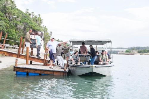a group of people on a boat on the water at Sibuya Game Reserve and Lodge in Kenton on Sea