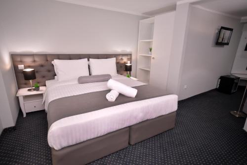 Postel nebo postele na pokoji v ubytování Alexandar Square Apartments