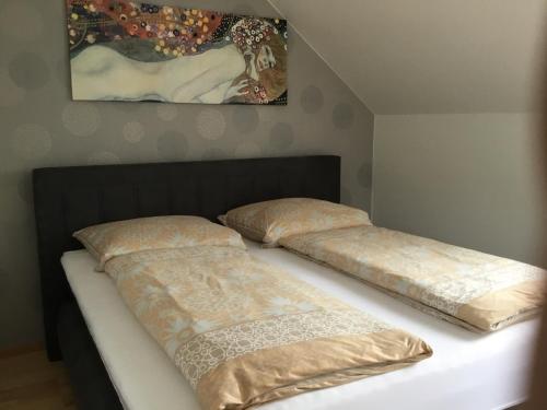two beds sitting on top of a bed at Ferienwohnung Villa Josephine in Badenweiler