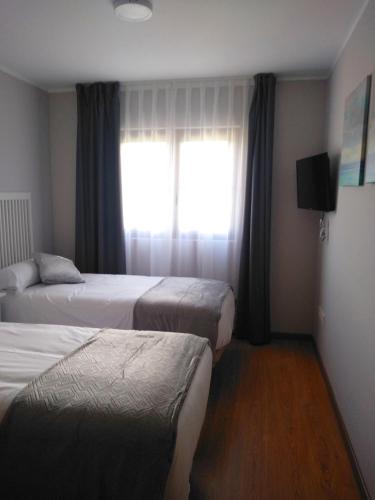 Кровать или кровати в номере Apartamentos Prestin