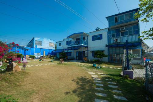 a large building with a yard in front of it at 布袋愛琴海Aegean Sea B&B Budai in Budai