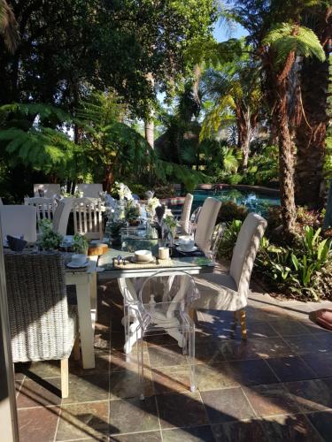 a white table and chairs on a patio at Meraki Country Manor in Lanseria