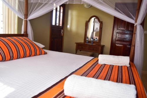 A bed or beds in a room at Tahira Villa