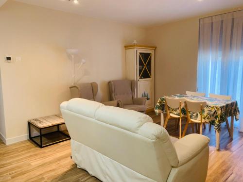 a living room with a white couch and a table at AZ El Balcón de Cesar Augusto in Zaragoza