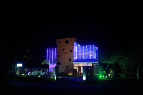 a building with blue lights on it at night at Palmtree Leaf, Munnar in Munnar